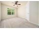 Neutral bedroom with ceiling fan, carpeted floors, and a bright window view at 205 Hammond Wood Pl, Morrisville, NC 27560