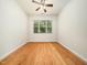 Bright, airy bedroom with hardwood floors and a large window offering natural light at 205 Hammond Wood Pl, Morrisville, NC 27560