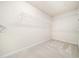 Walk-in closet with white wire shelving and neutral carpeting at 205 Hammond Wood Pl, Morrisville, NC 27560