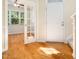 Welcoming foyer featuring hardwood floors, a front door, and glass French doors leading to another room at 205 Hammond Wood Pl, Morrisville, NC 27560