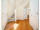 Bright foyer with hardwood floors, a carpeted staircase, and an open layout at 205 Hammond Wood Pl, Morrisville, NC 27560