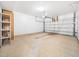 Large two car garage with painted floor, storage shelving and white walls at 205 Hammond Wood Pl, Morrisville, NC 27560
