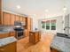 Bright kitchen features granite countertops, wood cabinets, stainless steel appliances, and a center island at 205 Hammond Wood Pl, Morrisville, NC 27560
