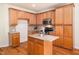 Well-equipped kitchen with wood cabinets, stainless steel appliances and granite countertops at 205 Hammond Wood Pl, Morrisville, NC 27560