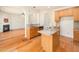 Open kitchen design with granite counters, stainless steel appliances, and views to the living room at 205 Hammond Wood Pl, Morrisville, NC 27560