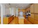 Spacious kitchen with wood floors, stainless steel appliances, granite countertops and a breakfast bar at 205 Hammond Wood Pl, Morrisville, NC 27560