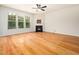 Spacious living room featuring a fireplace, hardwood floors, and many windows at 205 Hammond Wood Pl, Morrisville, NC 27560