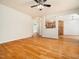 Bright living room with hardwood floors, featuring seamless transition to kitchen and dining spaces at 205 Hammond Wood Pl, Morrisville, NC 27560