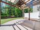 Covered patio space with fan and lights overlooking the backyard at 205 Hammond Wood Pl, Morrisville, NC 27560