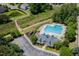 Community pool aerial view featuring ample seating, clubhouse, and convenient parking at 205 Hammond Wood Pl, Morrisville, NC 27560