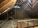 Unfinished attic with exposed rafters, wood framing, and insulation visible at 206 Kettlebridge Dr, Cary, NC 27511