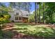 Large backyard with mature trees and partial view of the home at 206 Kettlebridge Dr, Cary, NC 27511