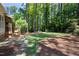Spacious backyard features a stone patio and lush green grass surrounded by trees at 206 Kettlebridge Dr, Cary, NC 27511