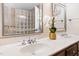 Lavish bathroom vanity with double sinks, marble countertops, and white floral arrangement at 206 Kettlebridge Dr, Cary, NC 27511