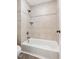 Clean white bathtub and tiled shower combination, equipped with a brushed nickel shower head and faucet at 206 Kettlebridge Dr, Cary, NC 27511