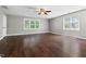 Spacious bedroom with dark hardwood flooring, ceiling fan, and large windows at 206 Kettlebridge Dr, Cary, NC 27511