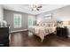Calm primary bedroom suite features neutral decor, ceiling fan, and two windows with natural light at 206 Kettlebridge Dr, Cary, NC 27511