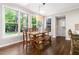 Bright dining area with large windows, a wooden dining table, and stylish pendant lighting at 206 Kettlebridge Dr, Cary, NC 27511