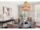 A bright dining room features a beaded chandelier and large windows with decorative shutters at 206 Kettlebridge Dr, Cary, NC 27511