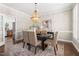 Elegant dining room with a beaded chandelier, decorative rug, and ample seating at 206 Kettlebridge Dr, Cary, NC 27511