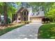 Charming brick home with a two-car garage and inviting front yard, nestled among mature trees at 206 Kettlebridge Dr, Cary, NC 27511