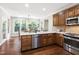 Beautiful kitchen featuring a breakfast bar, stainless steel appliances, and a sun-drenched breakfast area at 206 Kettlebridge Dr, Cary, NC 27511