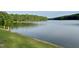 Scenic view of the lake bordered by lush greenery and a wooden fence at 206 Kettlebridge Dr, Cary, NC 27511