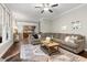 Spacious living room with hardwood floors, a large sectional sofa, and access to the kitchen at 206 Kettlebridge Dr, Cary, NC 27511