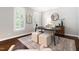 Bright home office with natural light, a comfortable chair, stylish rug and custom window shutters at 206 Kettlebridge Dr, Cary, NC 27511