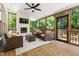 Screened in porch with brick fireplace, wicker furniture, ceiling fan, and wooded view at 206 Kettlebridge Dr, Cary, NC 27511