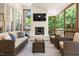 Relaxing sunroom with a brick fireplace and television for entertainment at 206 Kettlebridge Dr, Cary, NC 27511