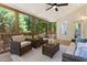 Cozy sunroom featuring wicker furniture and a ceiling fan for air circulation at 206 Kettlebridge Dr, Cary, NC 27511