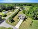 Aerial view of a charming home with a well-manicured lawn, driveway, and surrounding greenery at 2062 Montgomery Dr, Franklinton, NC 27525
