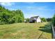 Expansive backyard featuring a lush lawn, mature trees, and a well-maintained fence at 2062 Montgomery Dr, Franklinton, NC 27525