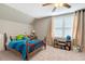 Comfortable bedroom featuring bright natural light and a ceiling fan at 2062 Montgomery Dr, Franklinton, NC 27525