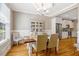 Elegant dining area showcasing hardwood floors, a modern chandelier, and plenty of natural light at 2062 Montgomery Dr, Franklinton, NC 27525