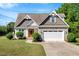 Charming home featuring a stone and vinyl facade, well-manicured lawn, and a two-car garage at 2062 Montgomery Dr, Franklinton, NC 27525