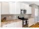 Spacious kitchen boasting white cabinets, granite countertops, and modern stainless steel appliances at 2062 Montgomery Dr, Franklinton, NC 27525