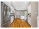 Bright kitchen featuring white cabinets, stainless steel appliances, and hardwood flooring at 2062 Montgomery Dr, Franklinton, NC 27525