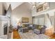 Bright living room features vaulted ceilings, hardwood floors, fireplace, and comfortable grey sectional sofa at 2062 Montgomery Dr, Franklinton, NC 27525