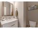 Powder room with framed mirror, a marble sink and modern fixtures at 2062 Montgomery Dr, Franklinton, NC 27525