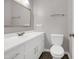 Bright bathroom features a white vanity, toilet, framed mirror, and modern fixtures at 207 Mcleod Dr, Sanford, NC 27330
