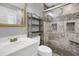 Bathroom showcasing glass shower with gray tile, built-in niche, and white vanity at 207 Mcleod Dr, Sanford, NC 27330