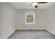 Bedroom with neutral walls, carpet, ceiling fan and window with tree view at 207 Mcleod Dr, Sanford, NC 27330