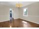 Dining area with hardwood floors, a chandelier and adjacent kitchen at 207 Mcleod Dr, Sanford, NC 27330