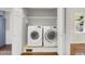 Convenient laundry area with a washer and dryer, plus storage shelves at 207 Mcleod Dr, Sanford, NC 27330