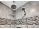 Modern shower featuring gray tiled walls and dual shower heads at 207 Mcleod Dr, Sanford, NC 27330