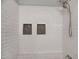 Modern shower featuring white tiled walls, niches and dual shower heads at 207 Mcleod Dr, Sanford, NC 27330