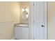 Bathroom features a vanity with a mirror and cabinet storage at 207 N Hopkins Ave, Spring Hope, NC 27882