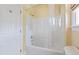 Bright bathroom showcases a tub-shower combo with clear curtain at 207 N Hopkins Ave, Spring Hope, NC 27882